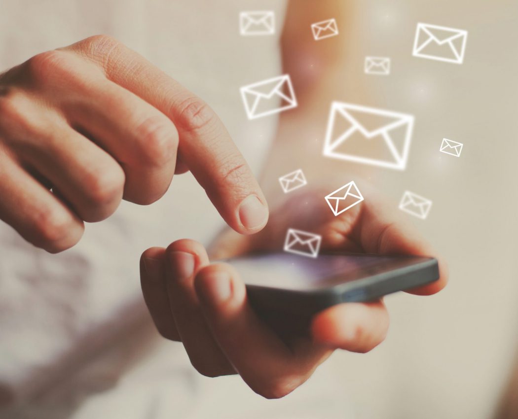 email marketing symbols coming out of a phone